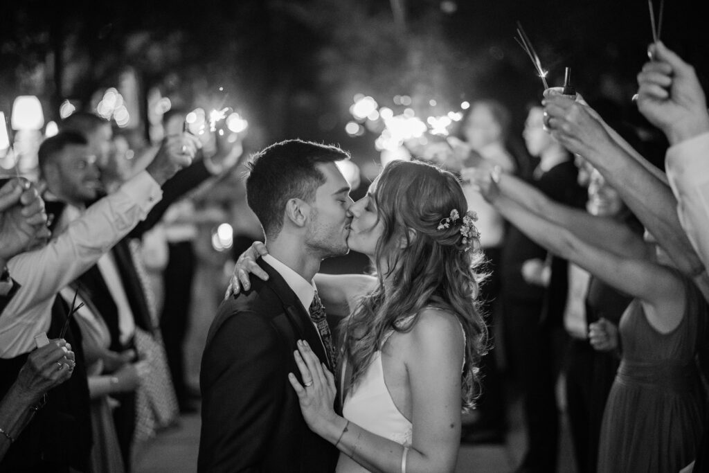 Brautpaar küssend unter Spalier mit Sternspritzer