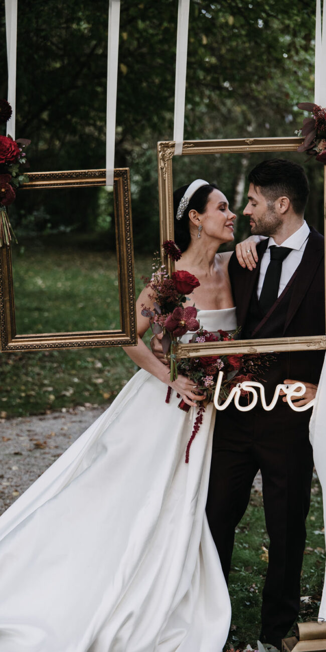 bride and groom couple shooting at picture frame station