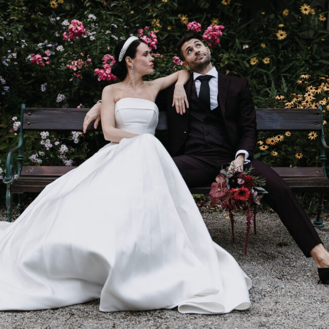 Brautpaar sitzt auf einer Parkbank
